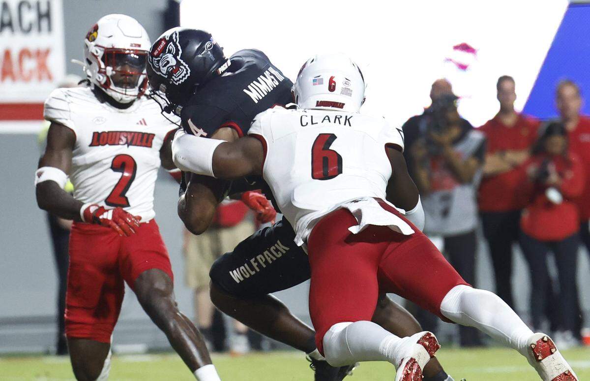 N.C. State running back Delbert Mimms III (34) beats Louisville linebacker Stanquan Clark (6) to score on a four-yard touchdown run during the first half of N.C. State’s game against Louisville at Carter-Finley Stadium in Raleigh, N.C., Friday, Sept. 29, 2023.