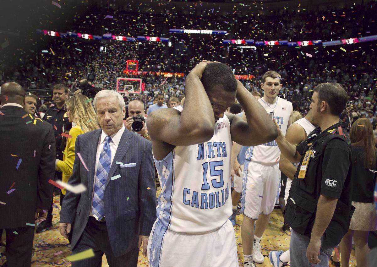 UNC's P.J. Hairston (15) and head coach Roy Williams leave the court amid a shower of confetti after Hairston's last second shot attempt to tie the game fell short, giving Florida State an 85-82 victory and their first ACC Tournament title on Sunday March 11, 2012 at Philips Arena in Atlanta, Georgia.