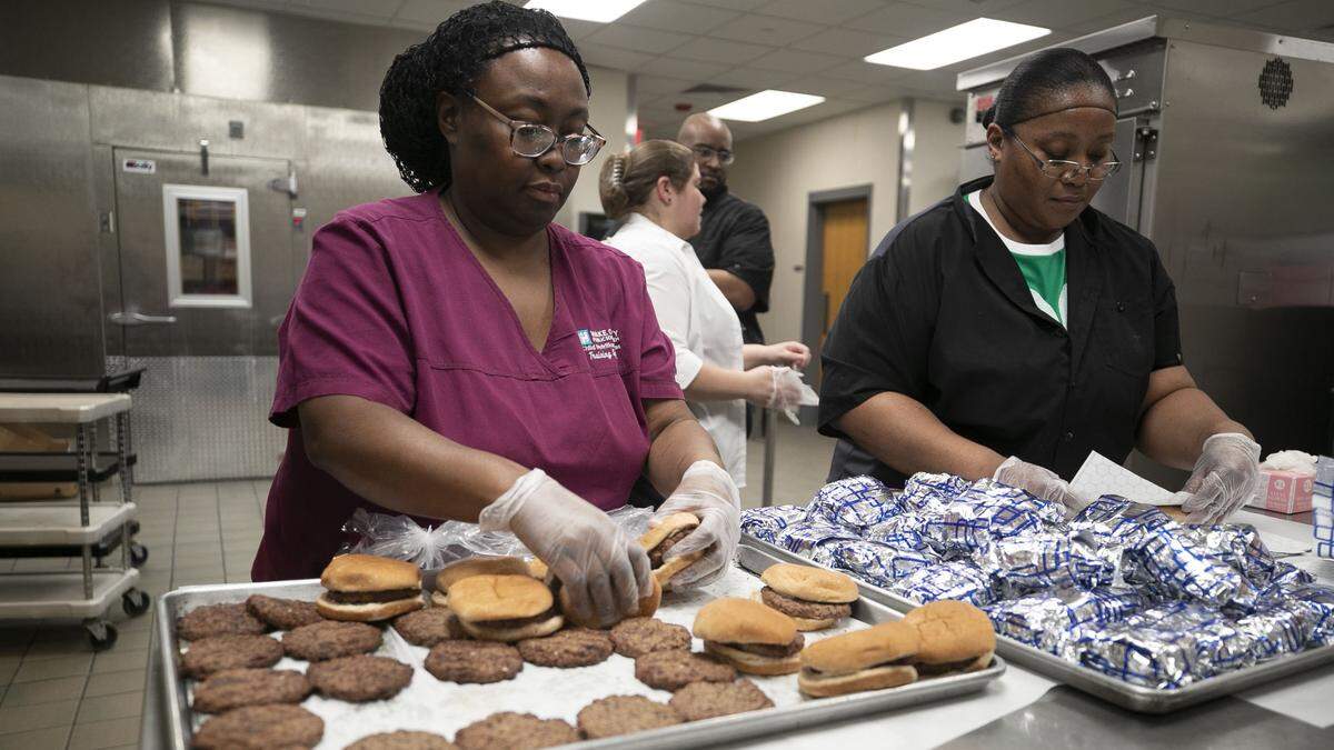 Wake County Child Nutrition Services employees prepare meals to be distributed to students while schools are closed due to the spread of the COVID-19 virus on Tuesday, March 17, 2020 at Wake Forest High School in Wake Forest, N.C.