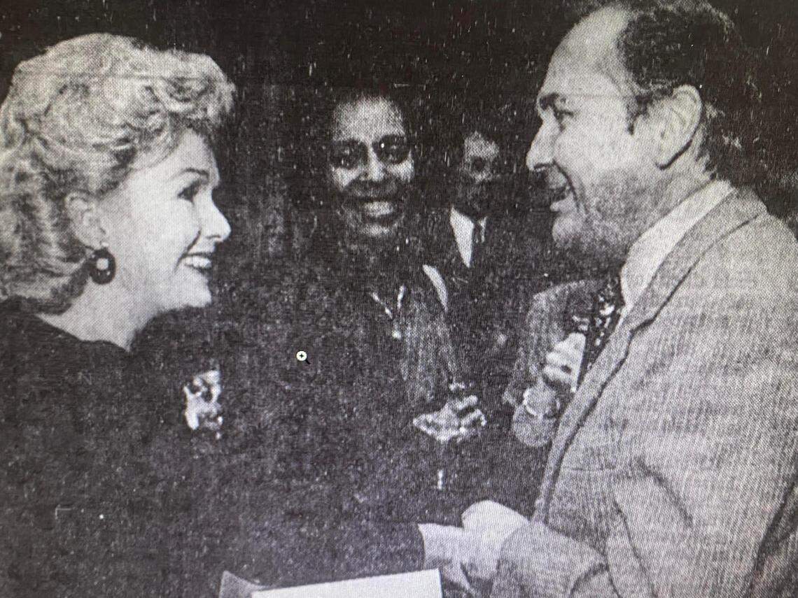 Cary florist Bob Strother greets Debbie Reynolds at a Raleigh performance in 1985, presenting her with a bouquet and reminiscing over the time they met in Las Vegas and she came to the table where he and his wife sat, thinking they were newlyweds.