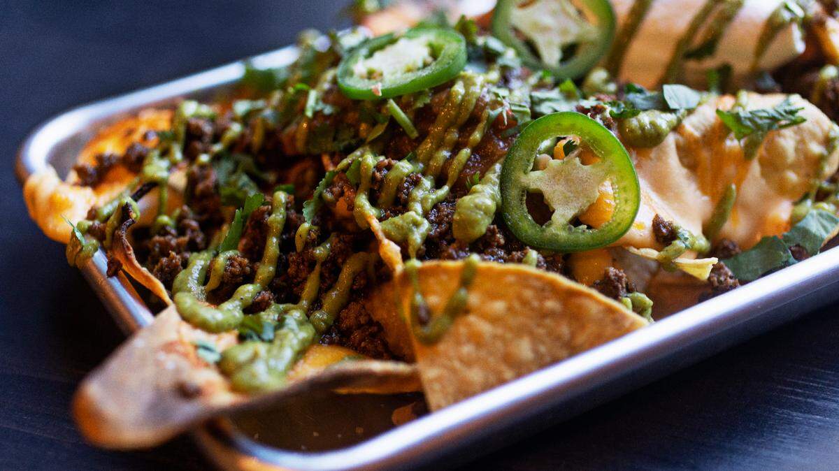 Queeny’s in downtown Durham includes a menu inspired by neighborhood bar and grills with menu items like these sheet pan nachos. It was recently named on of the best new restaurants in the South by Southern Living magazine.