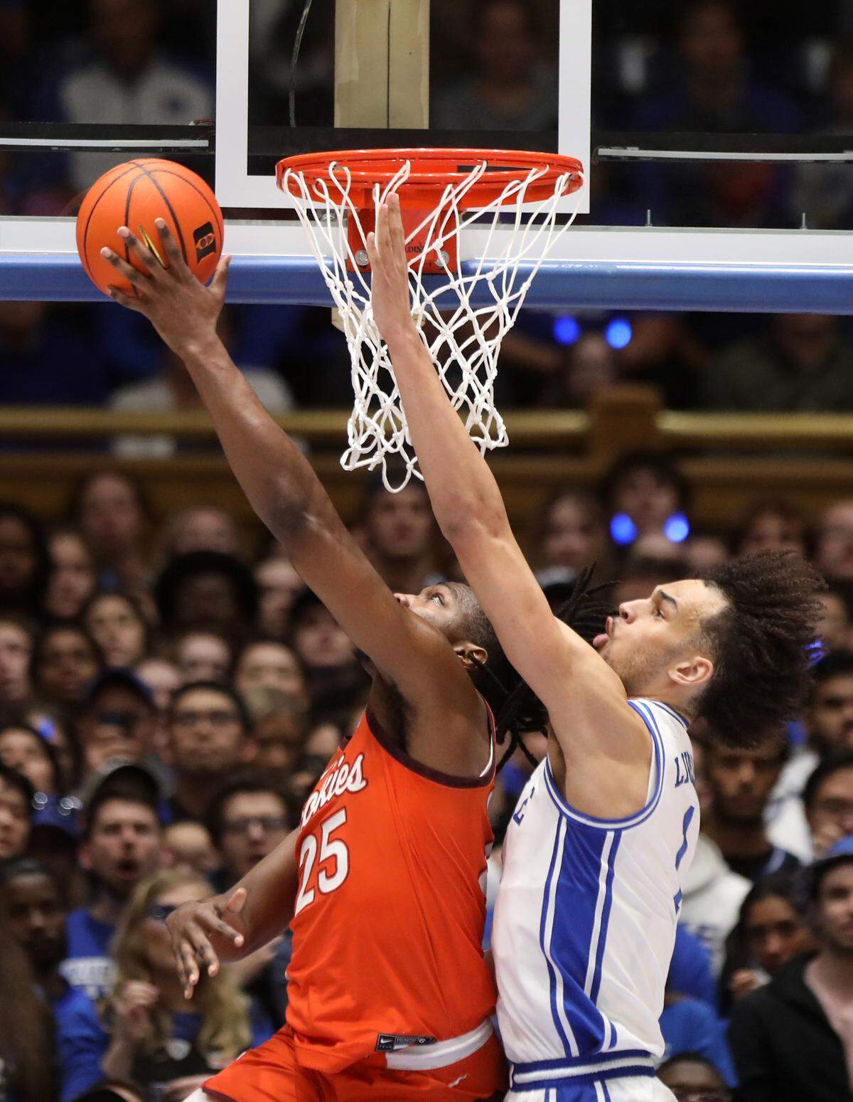 Virginia Tech’s Justyn Mutts is fouled by Duke’s Dereck Lively II during the first half of the Blue Devils’ game against Virginia Tech on Saturday, Feb. 25, 2023, at Cameron Indoor Stadium in Durham, N.C.