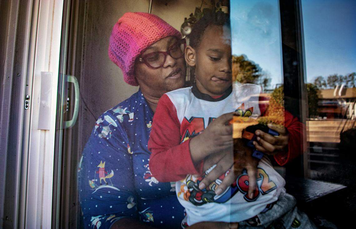 Shawnte Kelley and her son Andrew, 4, isolate in their Durham, N.C. apartment on Tuesday, Jan. 11, 2022 while waiting for their COVID-19 test results after Kelley was exposed to the virus at work.