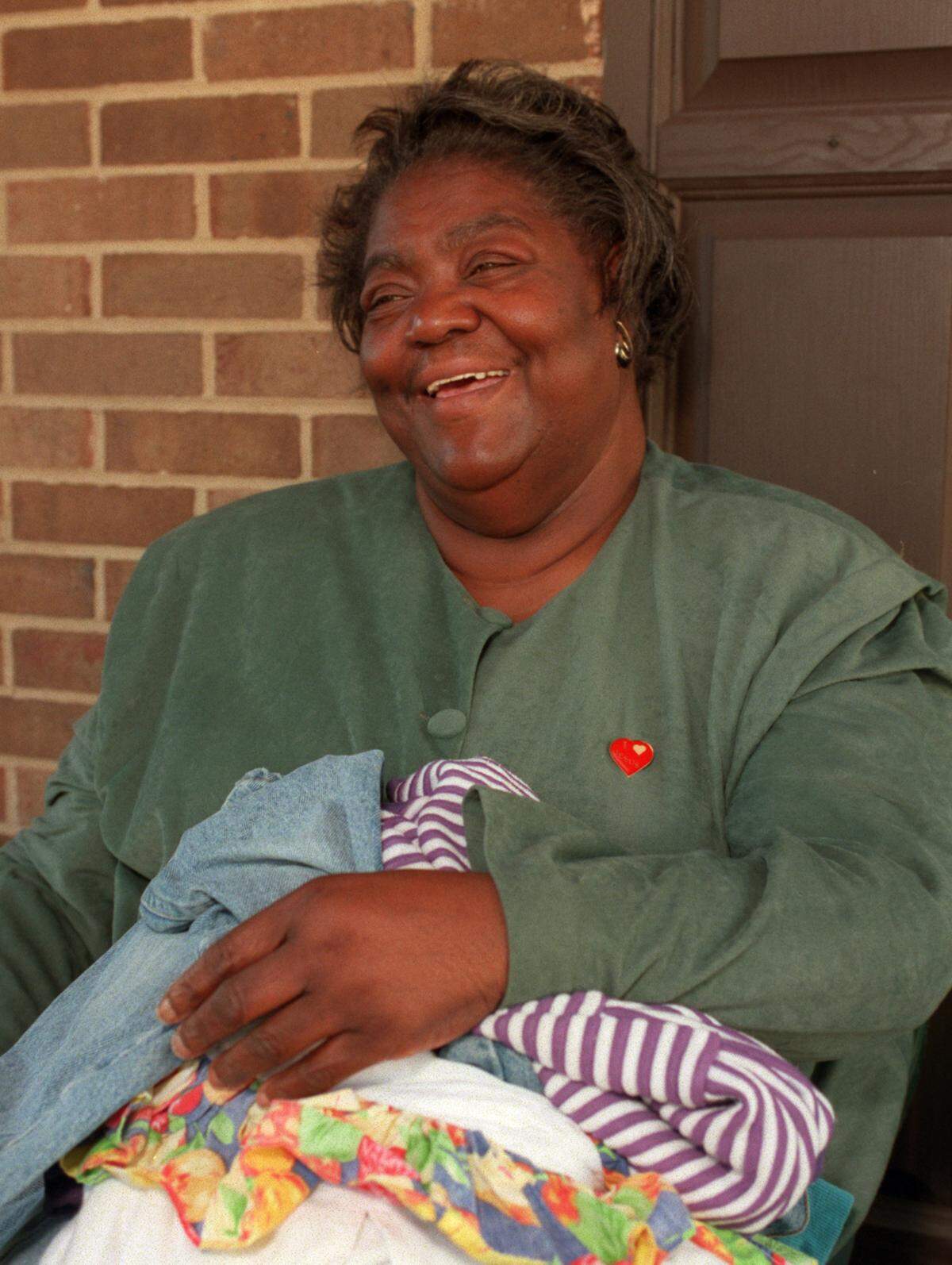 Ann Atwater, pictured Oct. 21, 1996, sorts through clothes that were dropped off on her front porch anonymously for distribution.