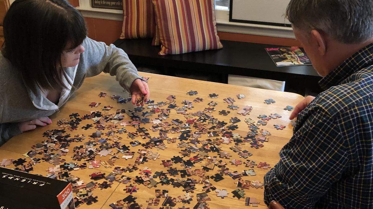 Parker and Thad Ogburn begin work on a “Friends” puzzle, the first of many to be worked during the coronavirus quarantine. Puzzles were a favorite of his mother, Betty Ogburn.