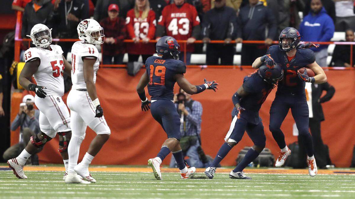 Syracuse linebacker Andrew Armstrong (12) celebrates with Scoop Bradshaw (18) after intercepting the ball late in the second half of Syracuse’s 51-41 victory over N.C. State at the Carrier Dome in Syracuse, N.Y., Saturday, Oct. 27, 2018.