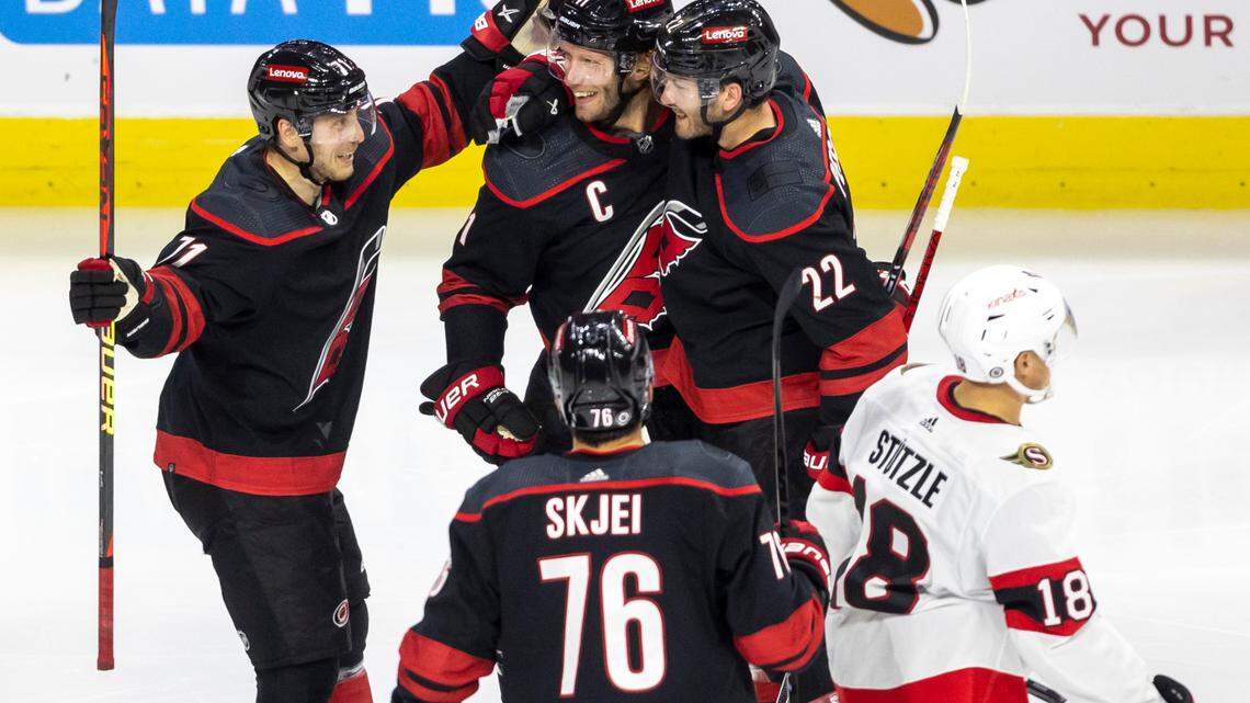 The Carolina Hurricanes Jesper Fast (71) and Brett Pesce (22) celebrate with Jordan Staal (11) after his goal in the third period on Wednesday, October 11, 2023 at PNC Arena, in Raleigh N.C.