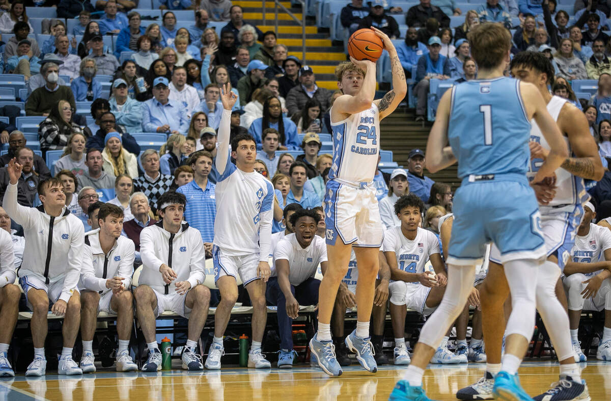 North Carolina’s Tyler Nickel (24) launches a three-point shot in front of the Tar Heels’ bench in the second half against The Citadel on Tuesday, December 13, 2022 at the Smith Center in Chapel Hill, N.C.