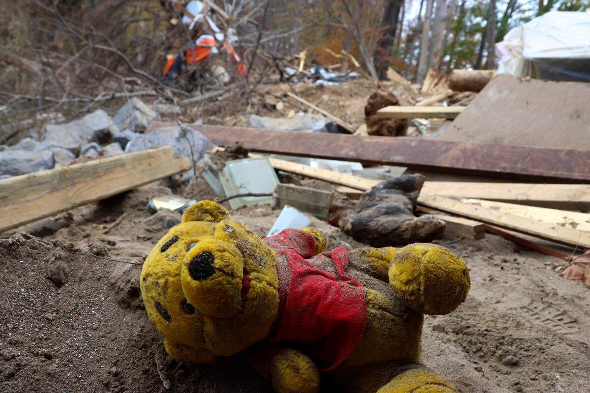 A dust-covered Winnie the Pooh toy lies among the debris in Swannanoa, N.C., on Oct. 27, 2024