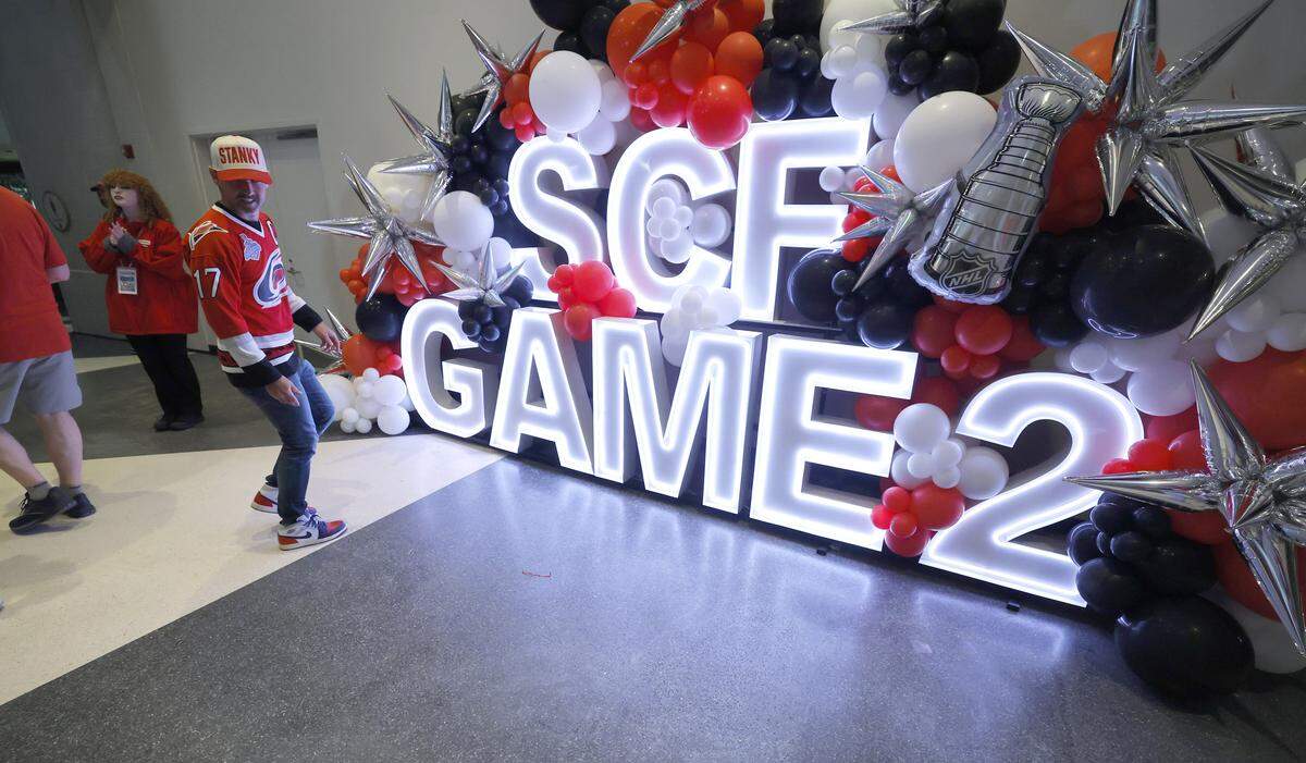 Fans head to pose in front of a sign set up in the concourse of the Lenovo Center before the HurricanesÕ game against the Golden Knights in the second game of the Stanley Cup Final at the Lenovo Center in Raleigh, N.C., Thursday, June 4, 2026.