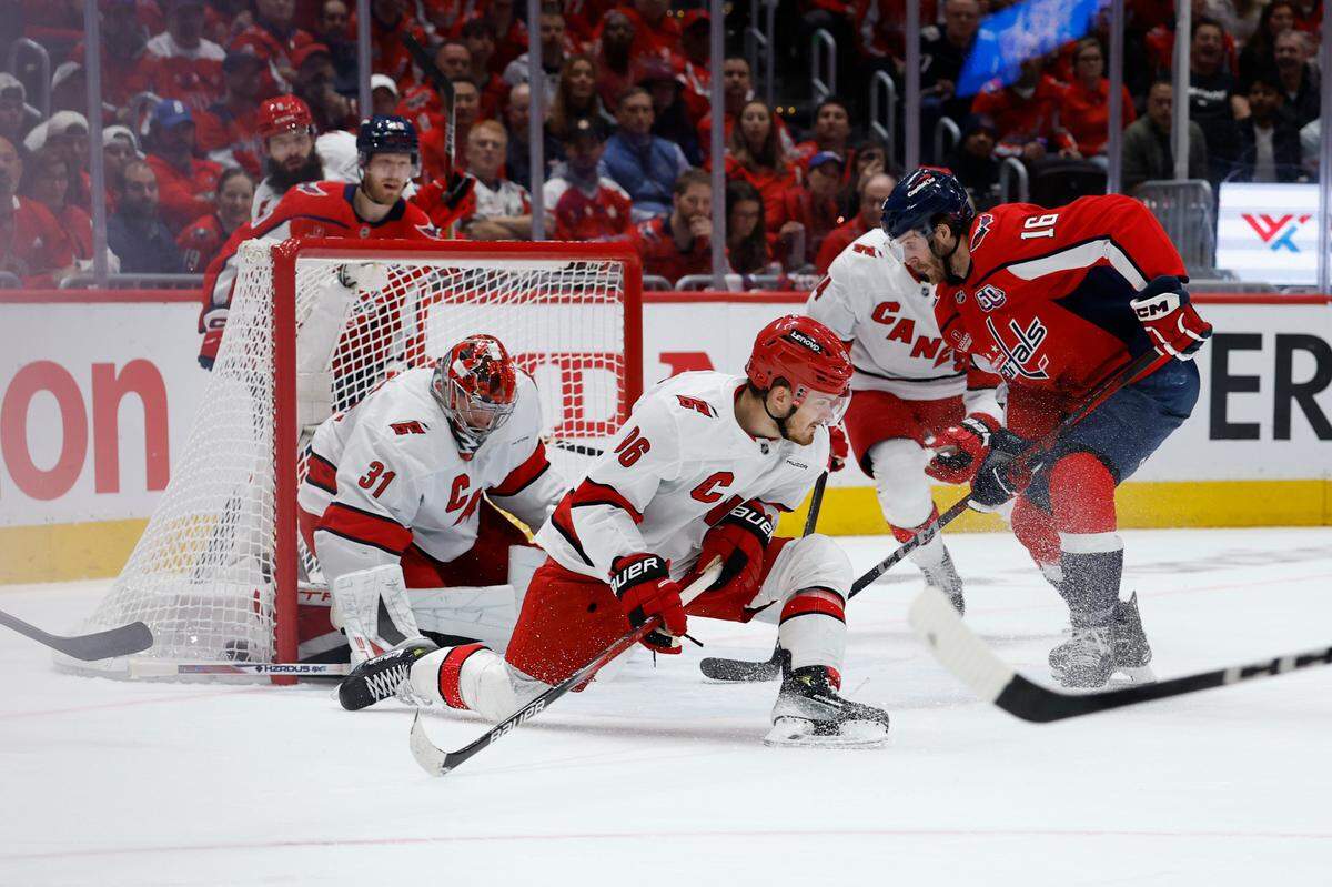 Carolina Hurricanes goaltender Frederik Andersen makes a save in front of Washington Capitals right wing Taylor Raddysh (16) as Hurricanes center Jack Roslovic (96) defends in the first period in game two of the second round of the 2025 Stanley Cup Playoffs at Capital One Arena.