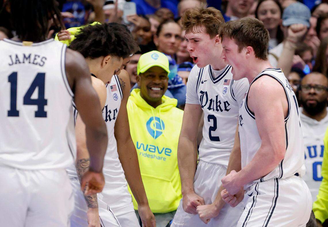 Duke’s Cooper Flagg (2) and Kon Knueppel (7) celebrate with teammates after Flagg made the basket while being fouled during the first half of Duke’s game against UNC at Cameron Indoor Stadium in Durham, N.C., Saturday, Feb. 1, 2025.