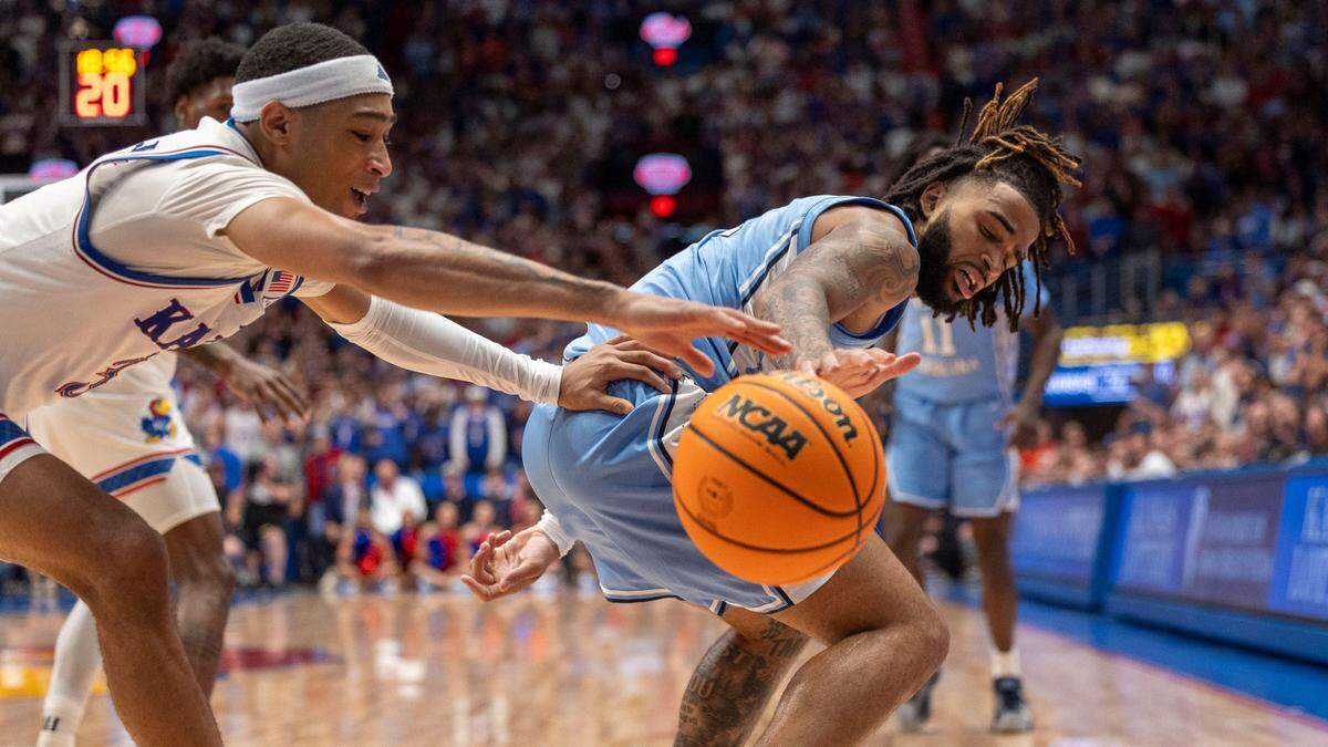 Kansas guard Dajuan Harris Jr (3) steals the ball from North Carolina guard R.J. Davis (4) in the second half on Friday, November 8, 2024 at Allen Fieldhouse in Lawrence, Kansas.