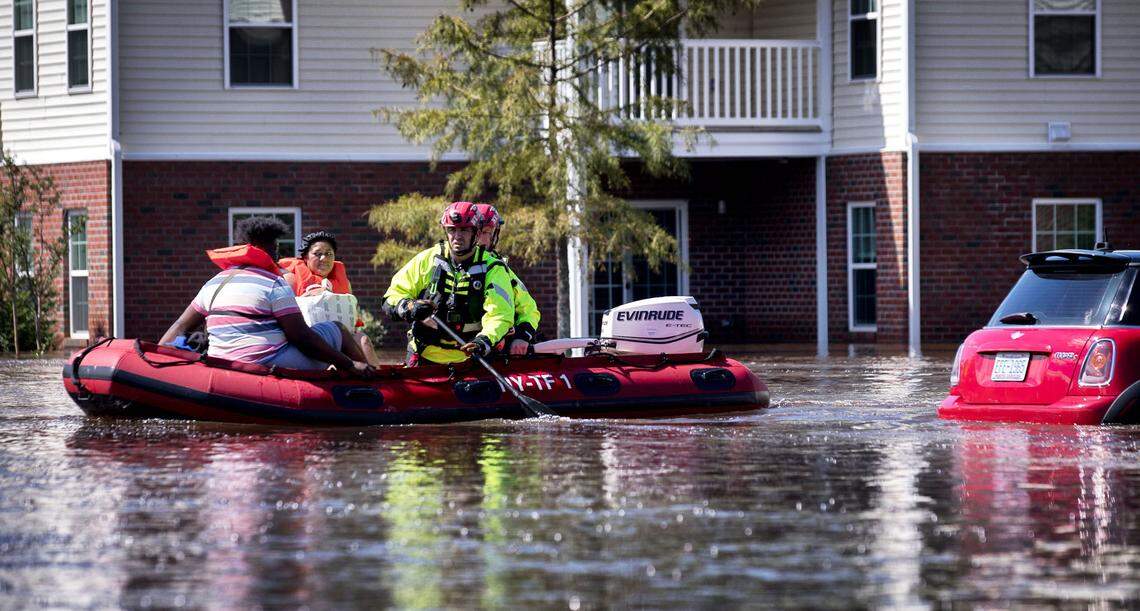 New York Urban Search and Rescue team members evacuate residents at the Heritage at Fort Bragg Apartments in Spring Lake, N.C., Tuesday Sept. 18, 2018.   