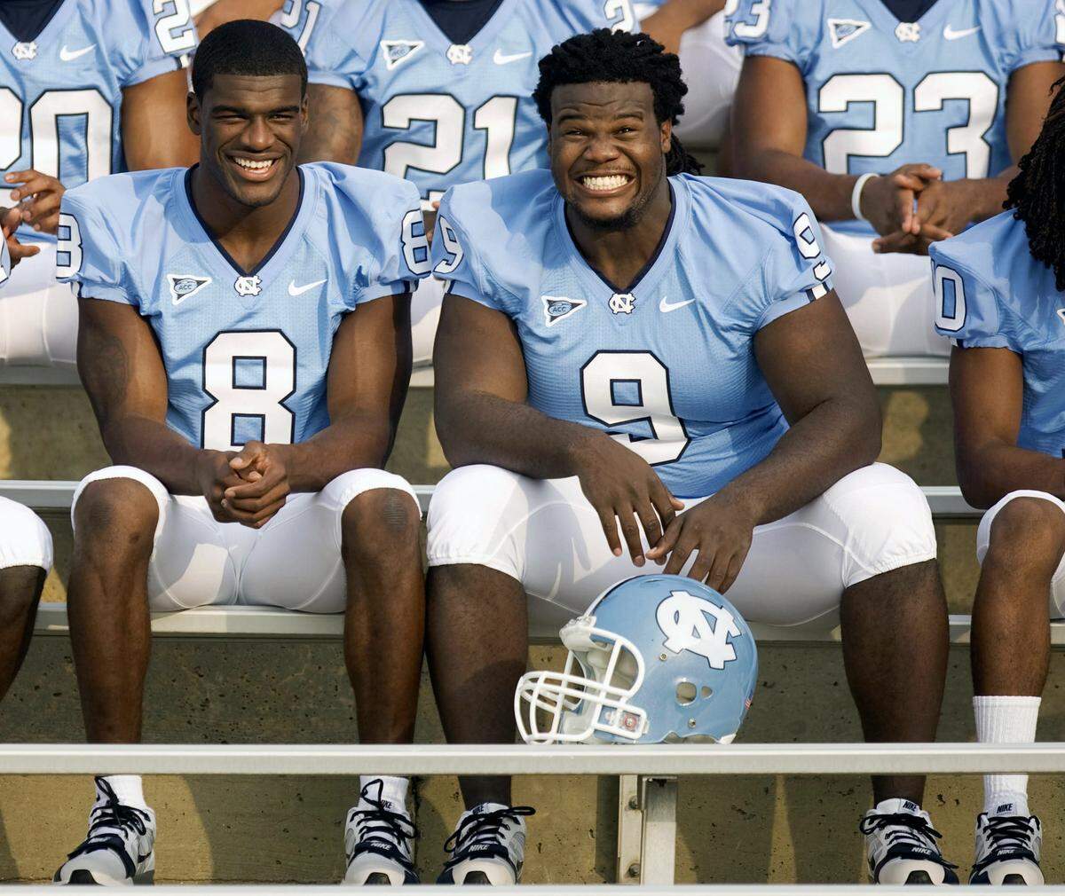 UNC seniors Greg Little (8) and Marvin Austin (9) joke around as they wait for the rest of the team to get into position for a team photo of the 2010 Tar Heel football squad on Friday morning August 6, 2010 at Kenan Stadium in Chapel Hill, N.C..
