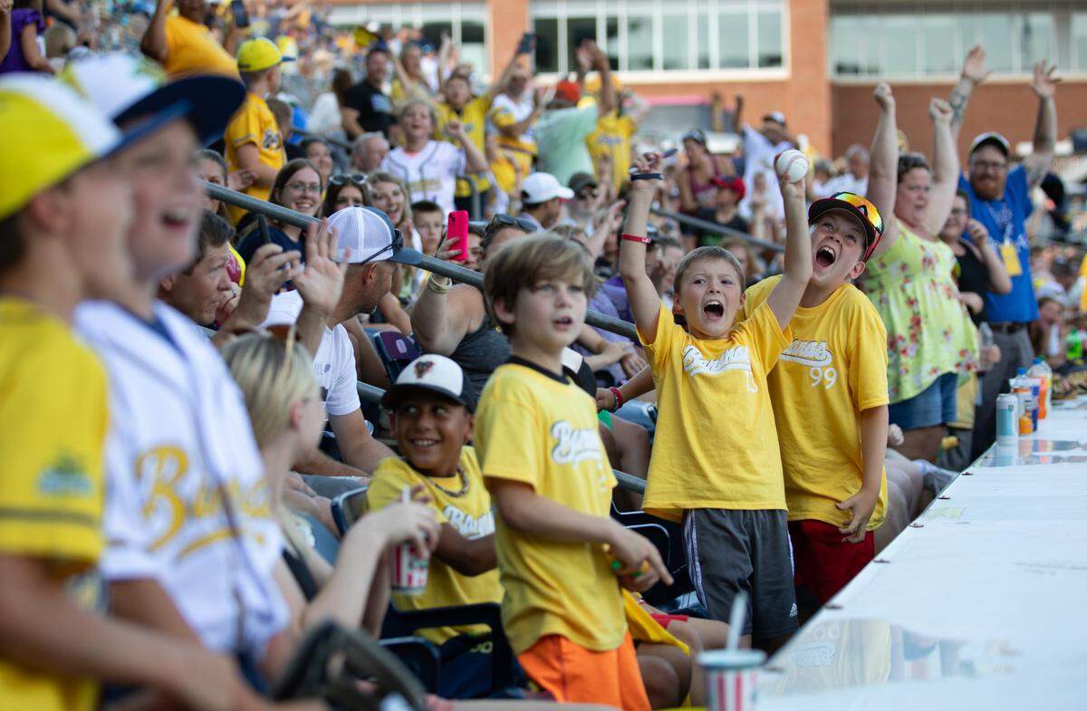 Savannah Bananas fans cheer for the Bananas during their pre-game show at Durham Bulls Athletic Park in Durham, N.C. on Friday, July 14, 2023.