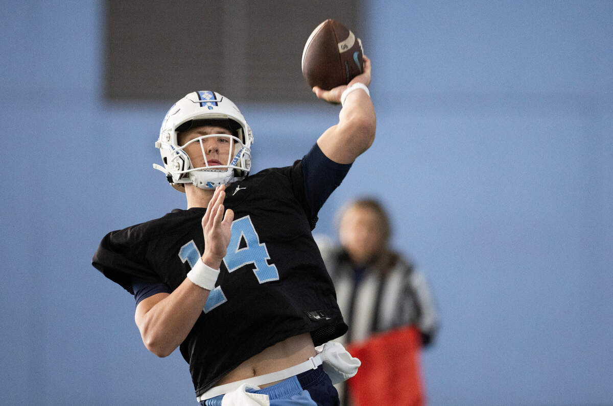 North Carolina graduate transfer quarterback Max Johnson (14) works out during the Tar Heels’ opening day of spring football practice on Tuesday, March 19, 2024 in Chapel Hill, N.C.