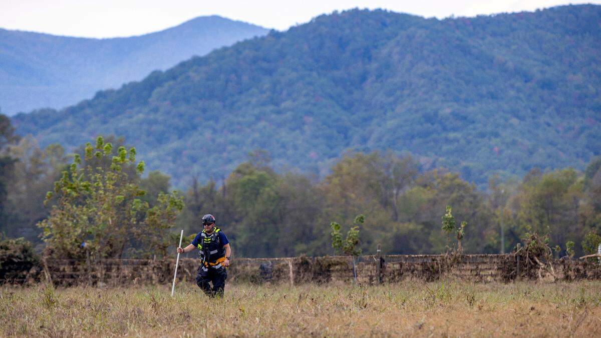 A member of a search and rescue team works a flooded field adjacent to the Catawba River, searching for victims of Hurricane Helene on Wednesday, October 2, 2024 near Old Fort, N.C.