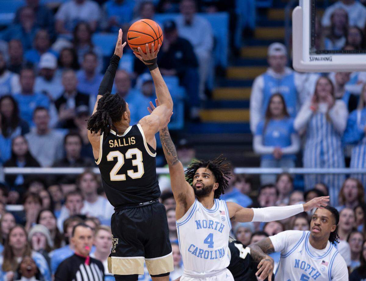 Wake Forest’s Hunter Sallis (23) puts up a shot over North Carolina’s R.J. Davis (4) during the first half on Monday, January 22, 2024 at the Smith Center in Chapel Hill, N.C.