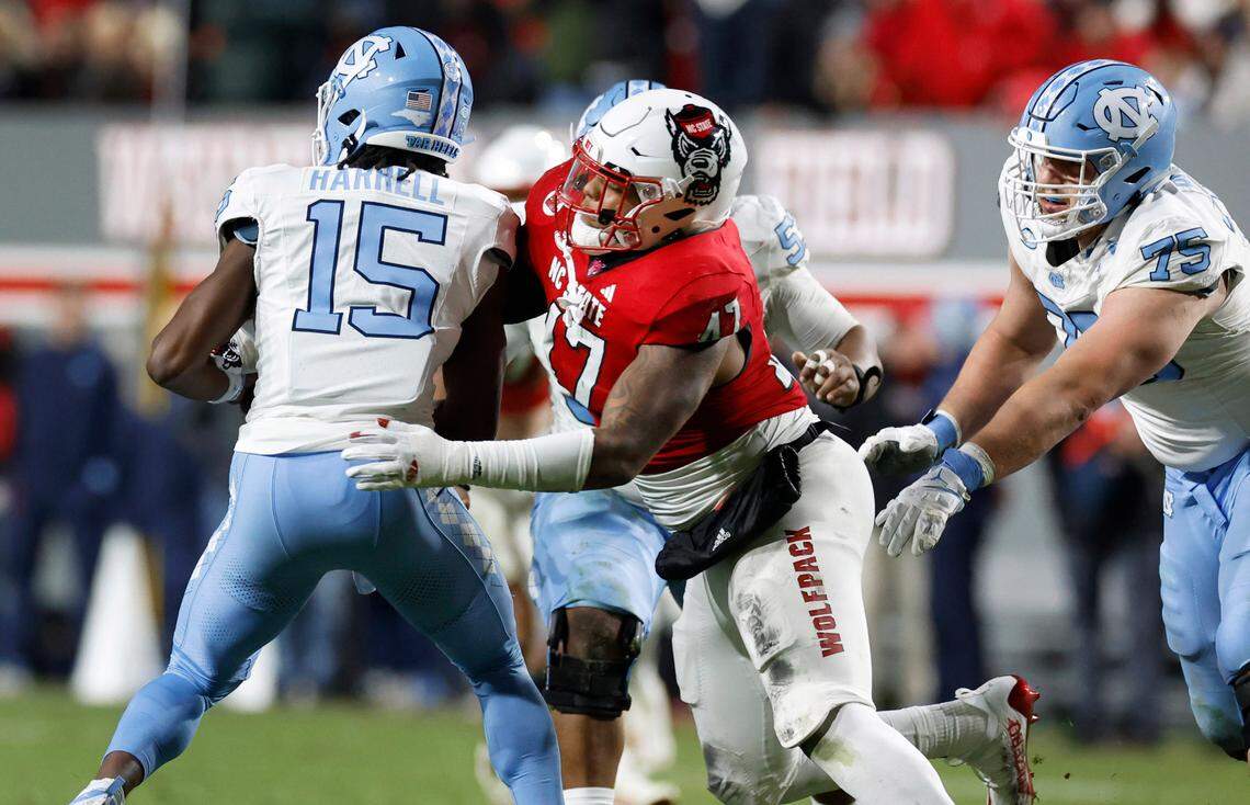 N.C. State defensive lineman Red Hibbler (47) sacks North Carolina quarterback Conner Harrell (15) during the second half of N.C. State’s 39-20 victory over UNC at Carter-Finley Stadium in Raleigh, N.C., Saturday, Nov. 25, 2023.