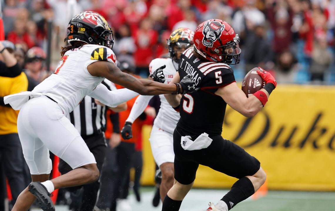 N.C. State wide receiver Thayer Thomas (5) looks to get past Maryland defensive back Deonte Banks (3) during the first half of N.C. State’s game against Maryland in the Duke’s Mayo Bowl at Bank of America Stadium in Charlotte, N.C., Friday, Dec. 30, 2022.