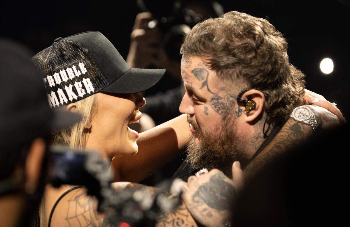 Jelly Roll and his wife Bunnie XO embrace before he took the stage on his “The Beautiful Broken Tour” at Raleigh, N.C.’s Lenovo Center, Friday night, Sept. 20, 2024.