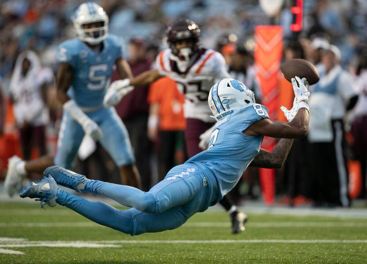 North Carolina wide receiver Kobe Paysour (8) stretches out trying to make a catch from quarterback Drake Maye in the third quarter against Virginia Tech on Saturday, October 1, 2022 at Kenan Stadium in Chapel Hill, N.C.