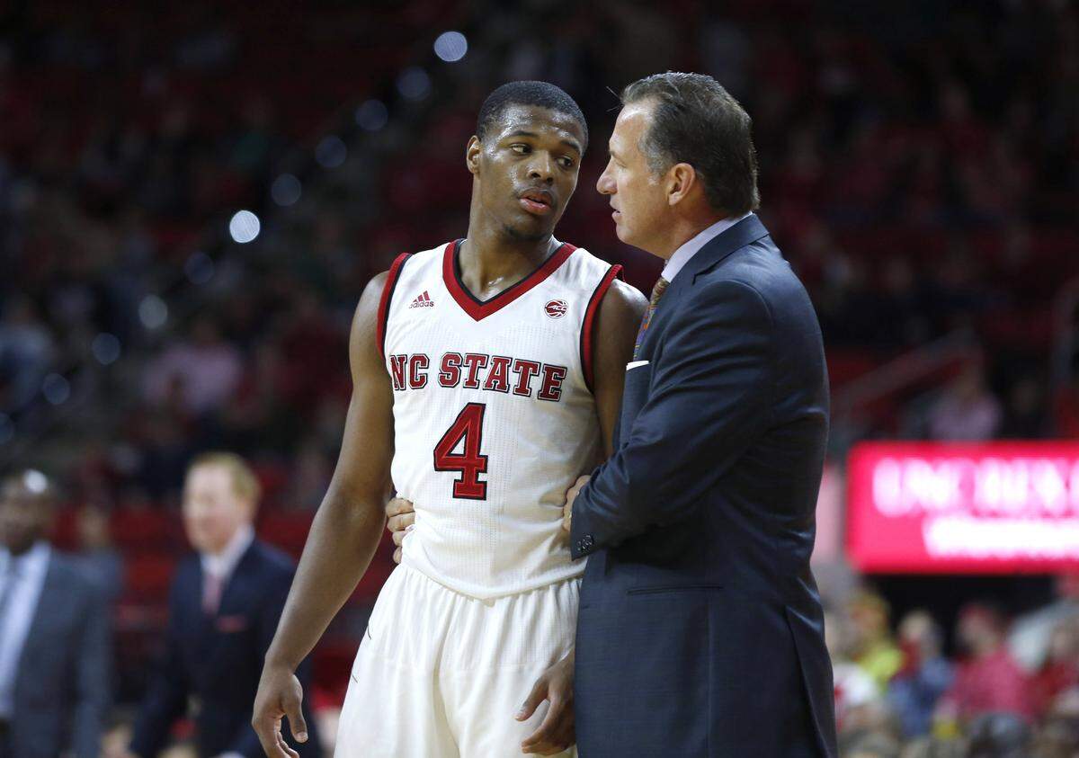 N.C. State’s head coach Mark Gottfried talks with Dennis Smith Jr. (4) during the Wolfpack’s 77-73 victory over Boston University at PNC Arena in Raleigh, N.C., Saturday, Dec. 3, 2016.
