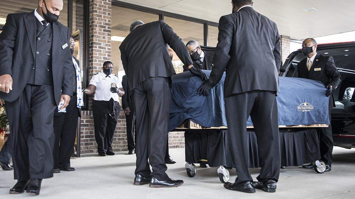 George Floyd’s casket is removed from a hearse outside the entrance to the R.L. Douglas Cape Fear Conference Center for a public viewing and private memorial service on Saturday, June 6, 2020 in Raeford, N.C. where Floyd was born.