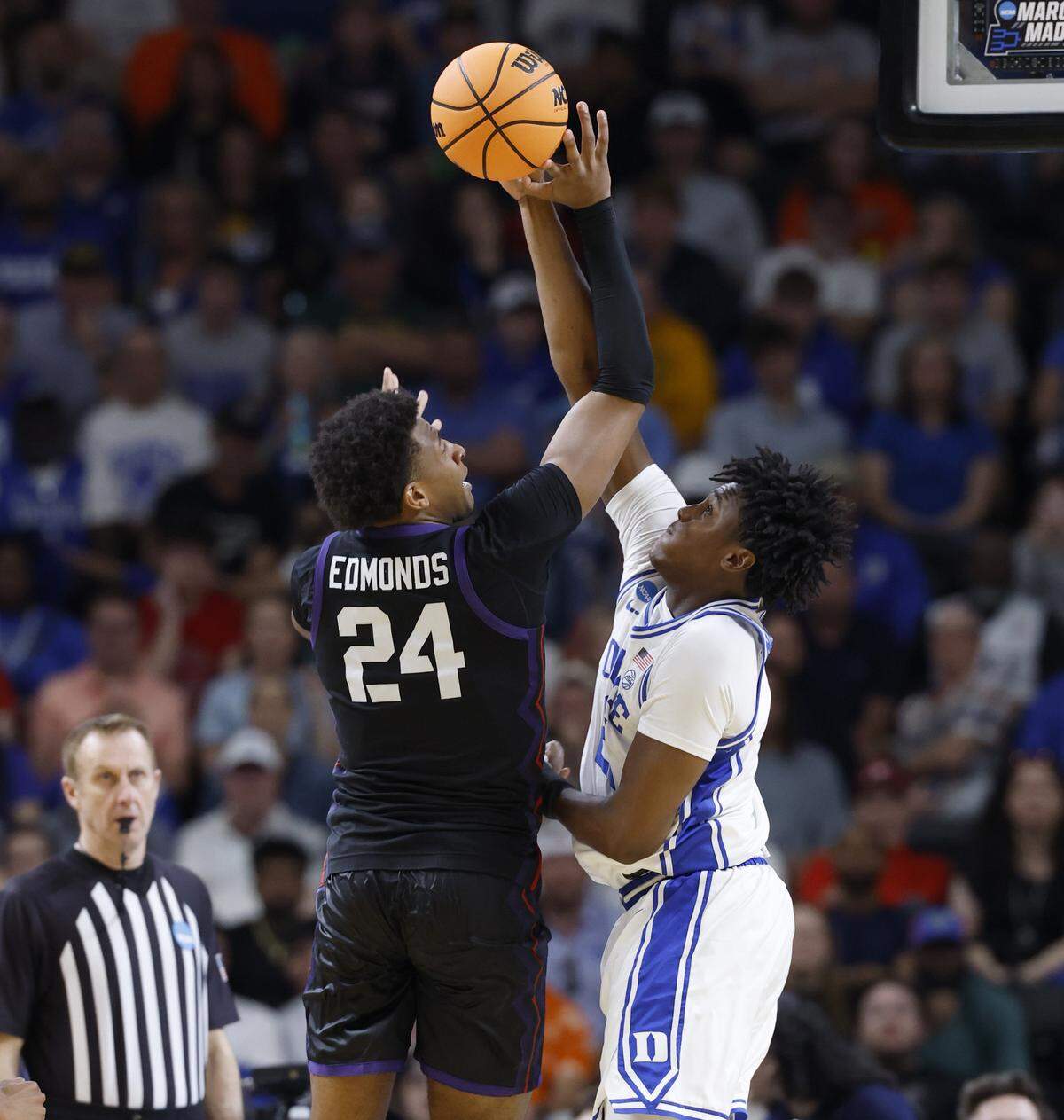 Duke’s Patrick Ngongba II (21) blocks the shot by TCU’s Xavier Edmonds (24) during the second half of Duke’s 81-58 victory over TCU in the second round of the NCAA Men’s Basketball Tournament at  Bon Secours Wellness Arena in Greenville, S.C., Saturday, March 21, 2026.