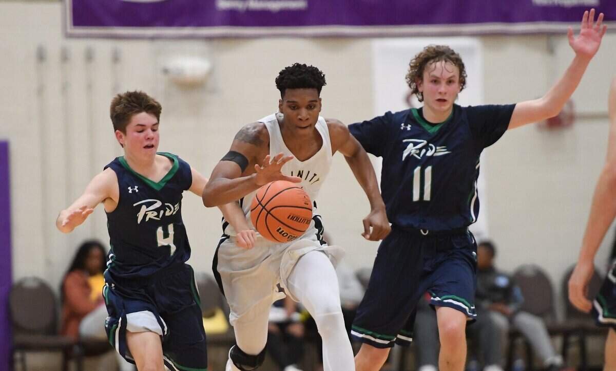 Isaiah Todd (14) of Trinity Academy brings the ball upcourt against Chase Hakerem (4) and Carter Whitt (11) of Leesville Road. The Trinity Academy Tigers played the Leesville Road Pride in a high school basketball game that was part of the John Wall Holiday Invitational Tournament in Raleigh, N.C. on December 26, 2018.