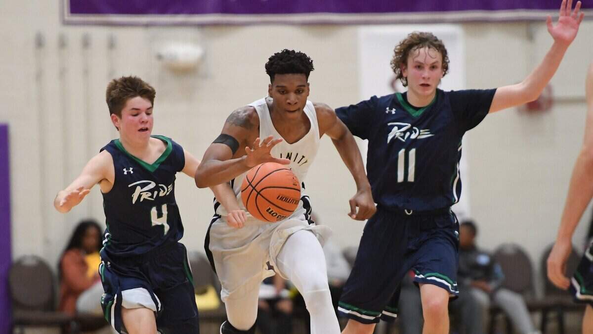 Isaiah Todd (14) of Trinity Academy brings the ball upcourt against Chase Hakerem (4) and Carter Whitt (11) of Leesville Road. The Trinity Academy Tigers played the Leesville Road Pride in a high school basketball game that was part of the John Wall Holiday Invitational Tournament in Raleigh, N.C. on December 26, 2018.