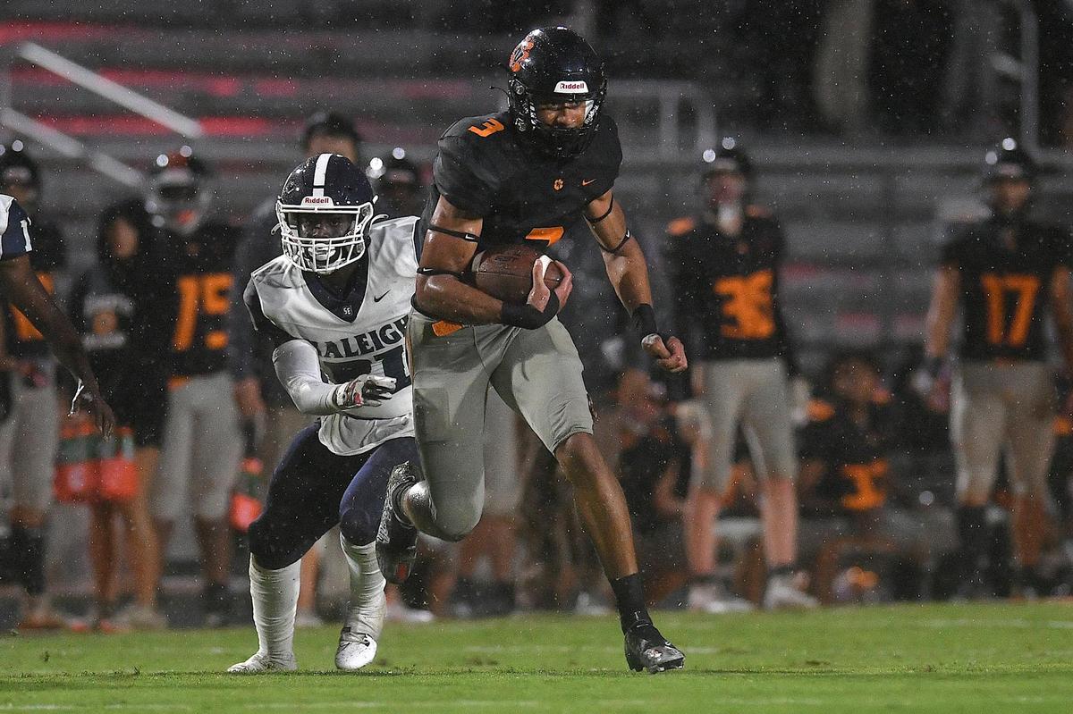 Fuquay-Varina’s Malcolm Ziglar (3) runs for yardage ahead of Southeast Raleigh’s Zayvion Williams (21).The Fuquay-Varina Bengals and the Southeast Raleigh Bulldogs played a conference football game in Fuquay-Varina, N.C. on September 22, 2023.