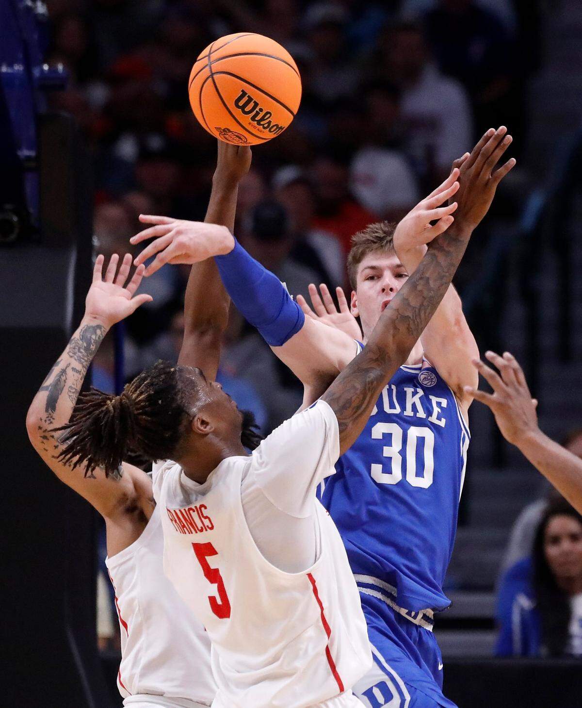 Duke’s Kyle Filipowski looks to pass beyond pressure from Houston’s Emanuel Sharp and Ja’Vier Francis during the second half of the Blue Devils’ 54-51 win over Houston in the NCAA Tournament Sweet 16 on Friday, March 29, 2024, at American Airlines Center in Dallas, Texas.