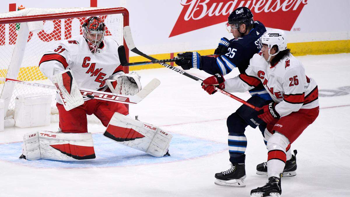 Carolina Hurricanes goaltender Frederik Andersen (31) makes a save on Winnipeg Jets’ Paul Stastny (25) during the first period of an NHL game in Winnipeg, Manitoba, Tuesday, Dec. 7, 2021. (Fred Greenslade/The Canadian Press via AP)