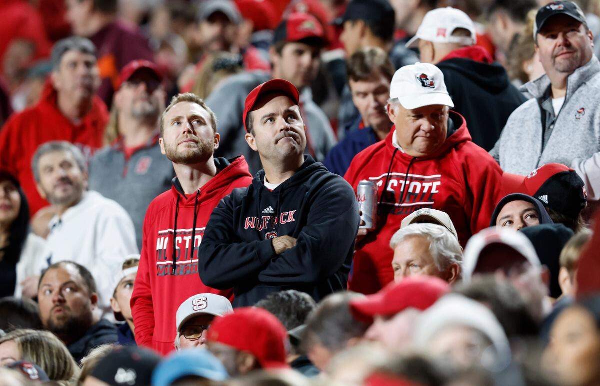Fans look up at the scoreboard after Virginia Tech scored during the second half of N.C. State’s 22-21 victory over Virginia Tech at Carter-Finley Stadium in Raleigh, N.C., Thursday, Oct. 27, 2022.