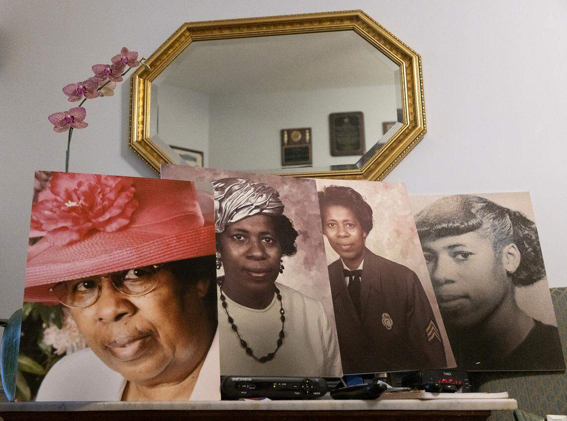 Photographs of Doris Williams, 91, sit atop a table in her home in Raleigh, N.C. on Thursday, Jan. 26, 2023. The house, which has been home to Williams since she was five years old, was bought in 1879 by her great-grandfather.