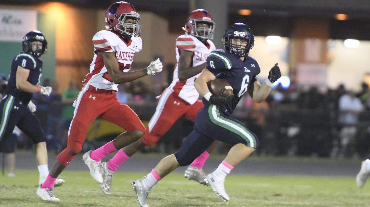 Andrew Doss (6) of Leesville Road moves the ball against the pursuit of Zyaire Hopkins, left, of Sanderson. The Sanderson Spartans visited the Leesville Road Pride in a high school football game on October 4, 2019.