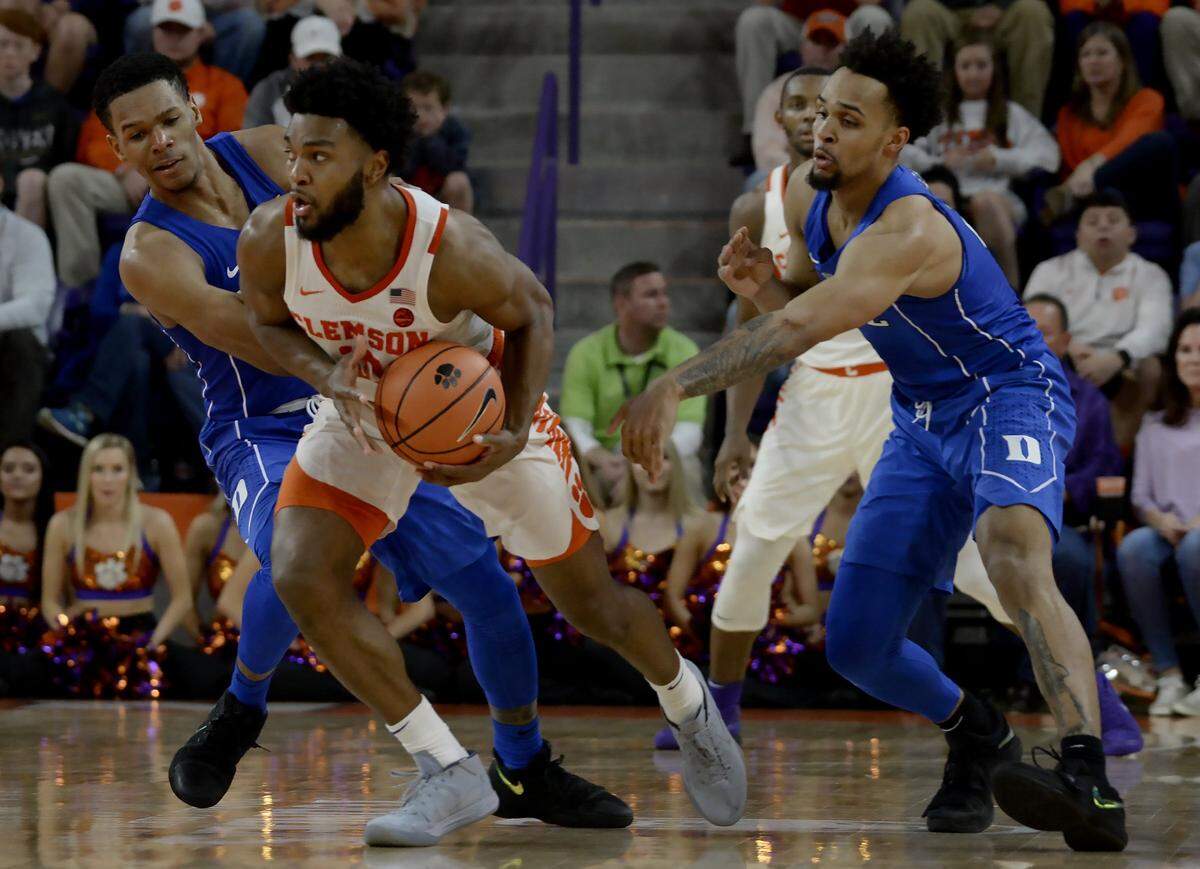 Guard Gabe DeVoe (10) is double teamed by Duke guard Trevon Duval (1) and guard Gary Trent Jr. (2) in the Blue Devils' 66-57 win over Clemson on Feb. 18. Duke coach Mike Krzyzewski switched to a zone defense for this game, and it has helped catapult the Blue Devils to a top-10 ranked defense in the country.