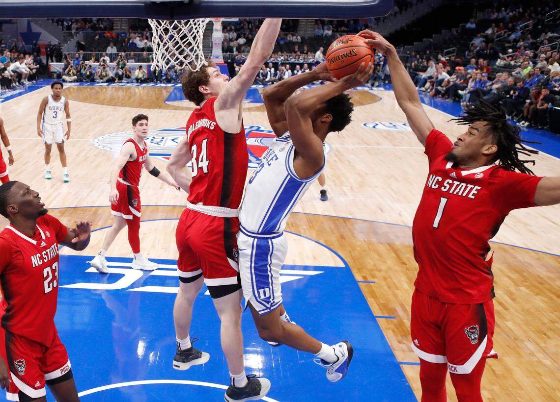 N.C. State’s Jayden Taylor (1) blocks the shot by Duke’s Sean Stewart (13) during N.C. State’s 74-69 victory over Duke in the quarterfinal round of the 2024 ACC Men’s Basketball Tournament at Capital One Arena in Washington, D.C., Thursday, March 14, 2024.