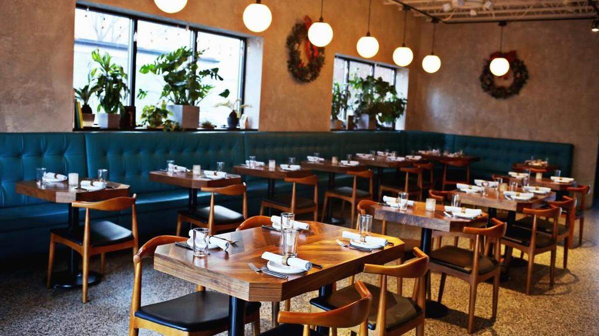 The Cortez is a compact space with an understated contemporary decor highlighted by tropical plants on the windowsills and banquette upholstery as blue as the Sea of Cortez on a sunny day.