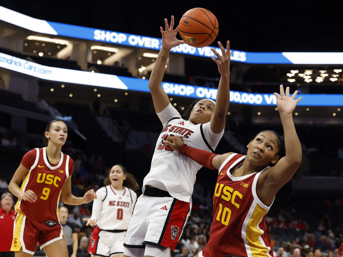 N.C. State’s Zoe Brooks pulls down a rebound over Southern California’s Malia Samuels during the second half of the Wolfpack’s 69-68 loss in the Ally Tipoff game on Sunday, Nov. 9, 2025, at Spectrum Center in Charlotte, N.C.
