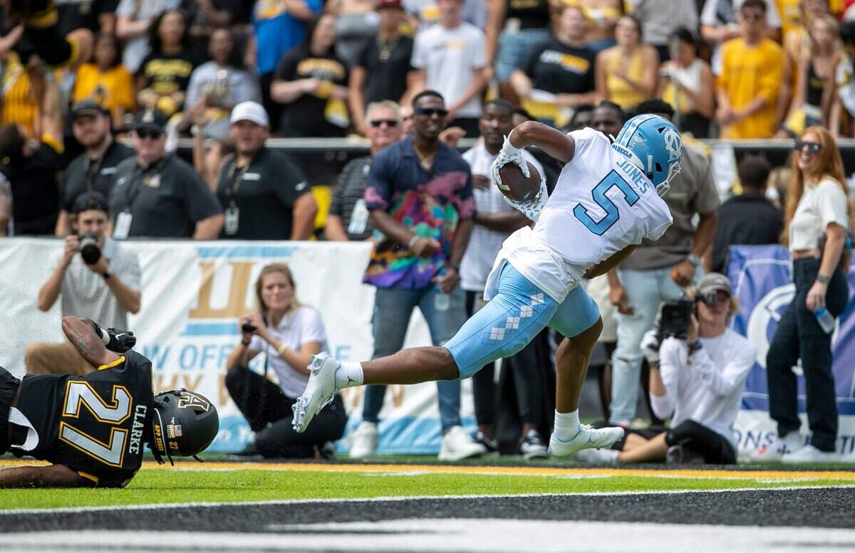 North Carolina’s J.J. Jones (5) scores a touchdown on a 23-yard pass play in the first quarter ahead of Appalachian States Ronald Clarke (27) on Saturday, September 3, 2022 at Kidd Brewer Stadium in Boone, N.C.
