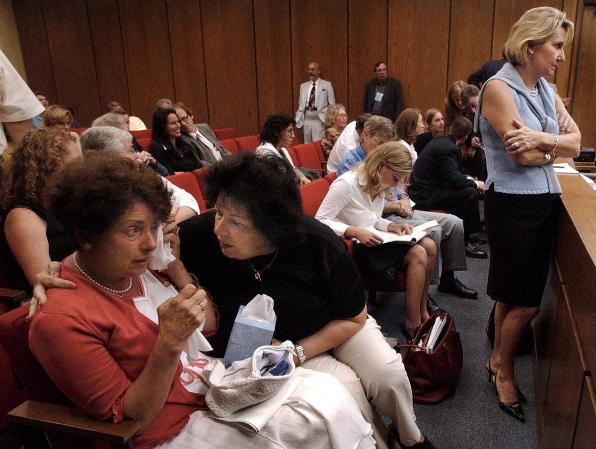 Margaret Blair (at left) is comforted by her sister Rosemary Kelloway after testifying in the Michael Peterson murder trial Monday. Blair took the stand to talk about her sister Elizabeth Ratliff who died in Germany in 1985. Ratliff’s death was similar to the death of Peterson’s wife Kathleen in December 2001. At far right is Kathleen Peterson’s sister Candace Zamperini.