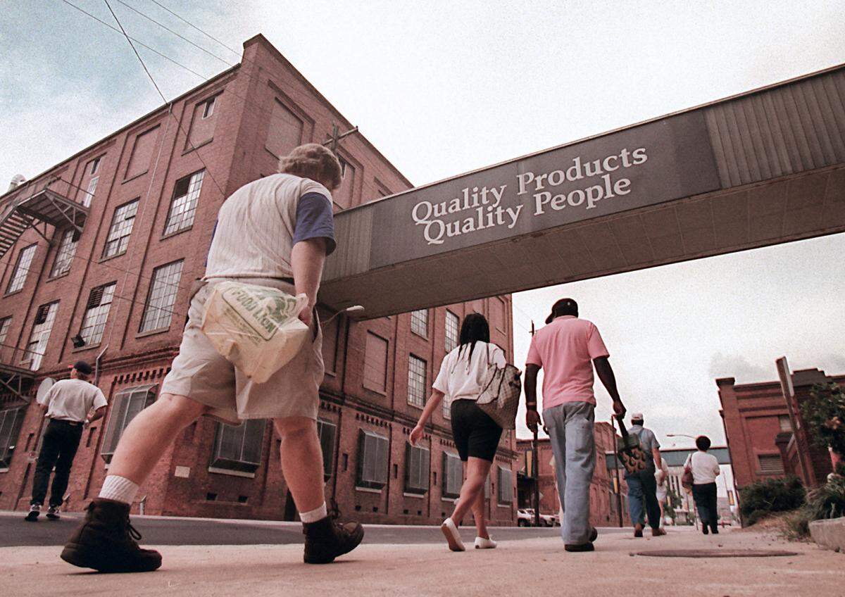 Employees leaves the Main Street building of Liggett & Myers in Durham at the end of their shift in 1996.