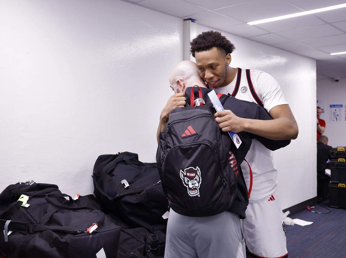N.C. State’s Quadir Copeland hugs head strength and conditioning coach Steven Soltysiak outside the locker room following the Wolfpack’s 68-66 loss to Texas in the NCAA First Four on Tuesday, March 17, 2026, at the University of Dayton Arena in Dayton, Ohio. 
