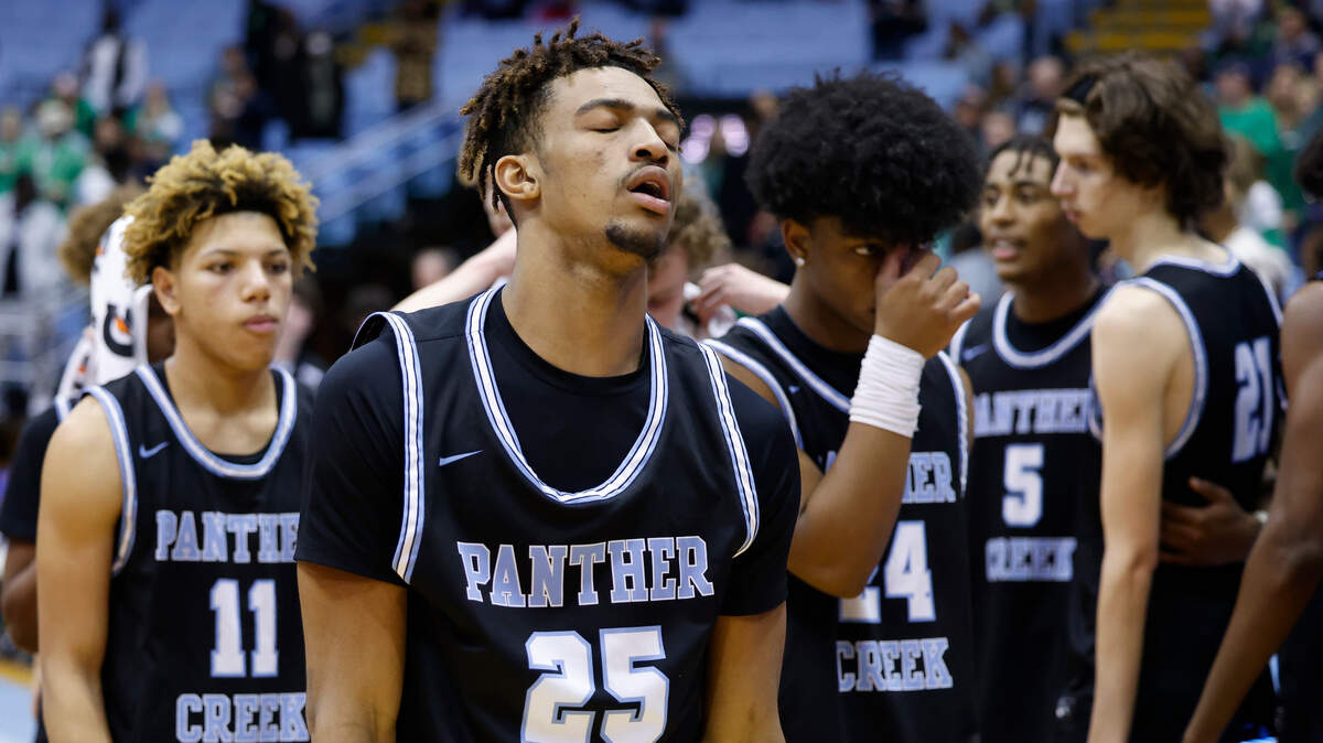 Panther Creek’s RaShaun Robinson (25) and other members of the team leave the court after the NCHSAA 4A basketball state championship game against Weddington at the Smith Center in Chapel Hill, N.C., Saturday, March 12, 2022. Weddington beat Panther Creek 76-58.