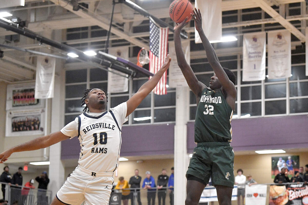 Northwood’s Drake Powell (22) launches the jump shot over Reidsville’s Cam’Ron Jones (10) during the first half in the John Wall Holiday Invitational. The Northwood Chargers and the Reidsville Rams met in a final of the John Wall Holiday Invitational in Raleigh, N.C. on December 30, 2023.