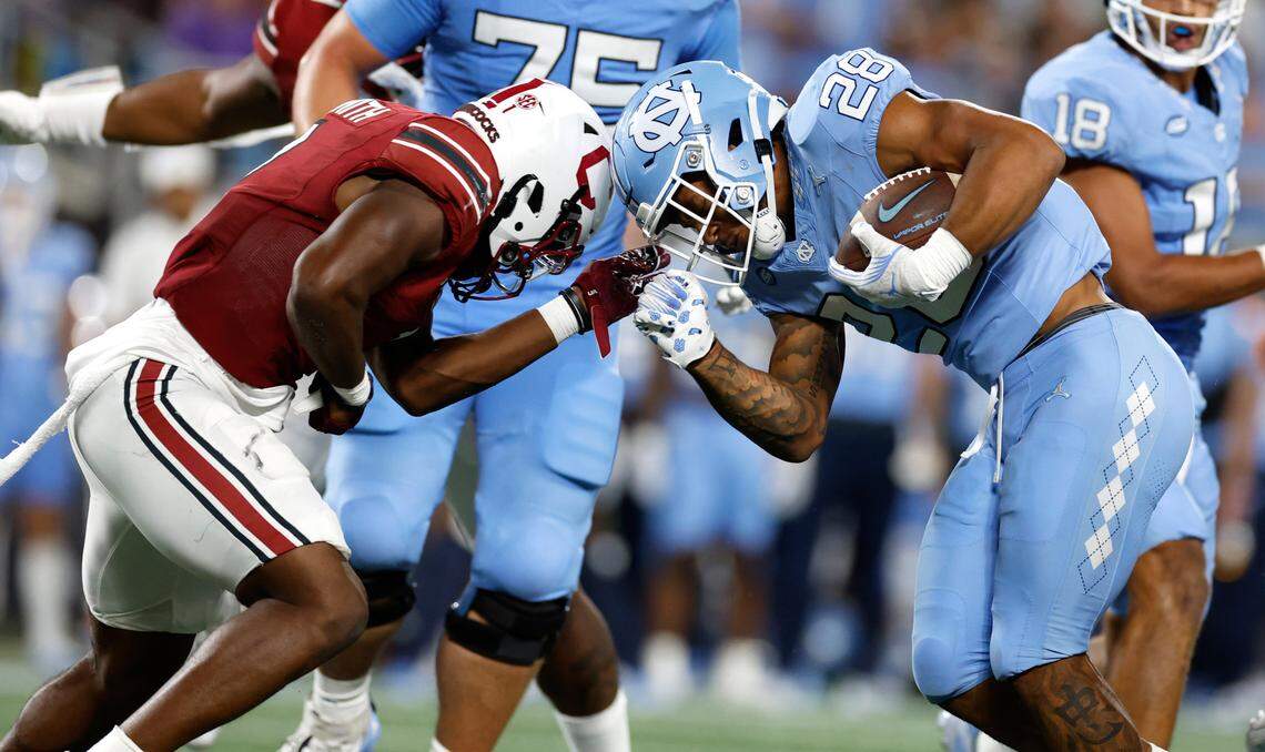 North Carolina running back Omarion Hampton (28) challenges South Carolina defensive back DQ Smith (1) during the second half of UNC’s 31-17 victory over South Carolina in the Duke’s Mayo Classic at Bank of America Stadium in Charlotte, N.C., Saturday, Sept. 2, 2023.