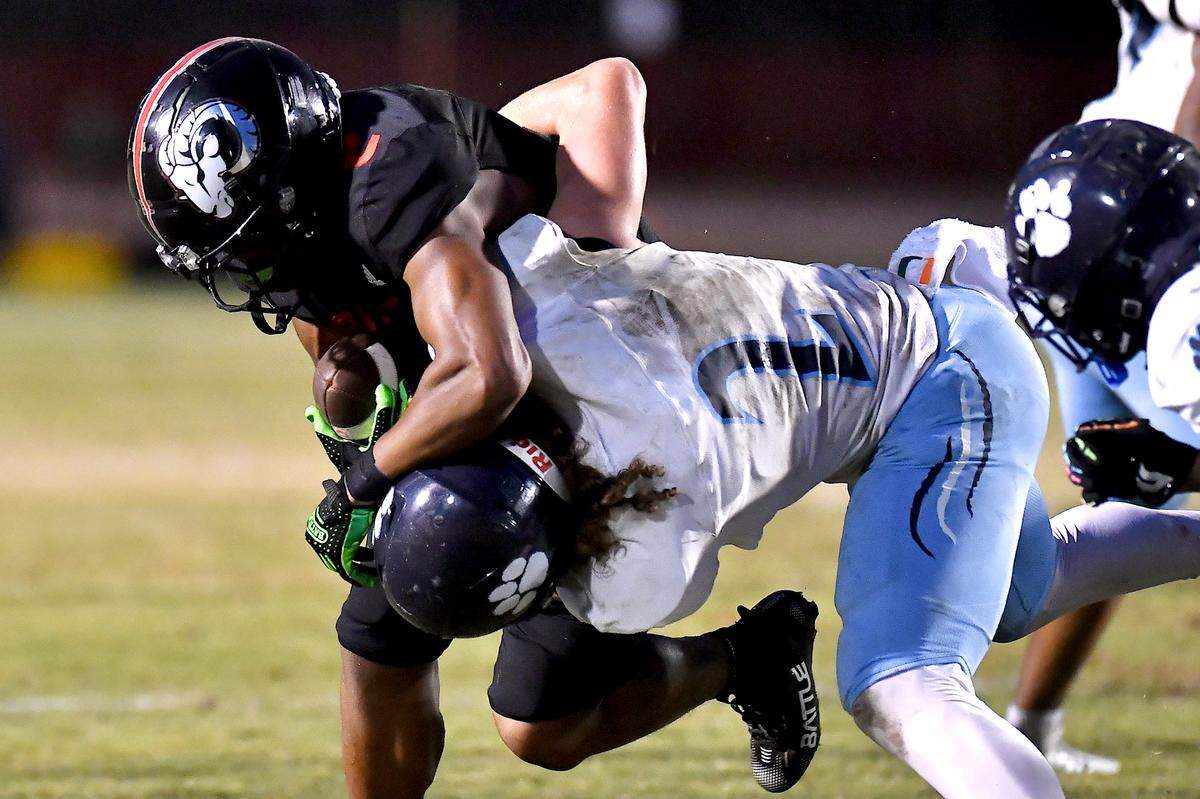 Millbrook Linebacker Quentin Cypher (2) tackles Rolesville running back Amir Brown (2) during the first half. The Millbrook Wildcats and the Rolesville Rams met in a conference football game in Rolesville, N.C. September 26, 2025